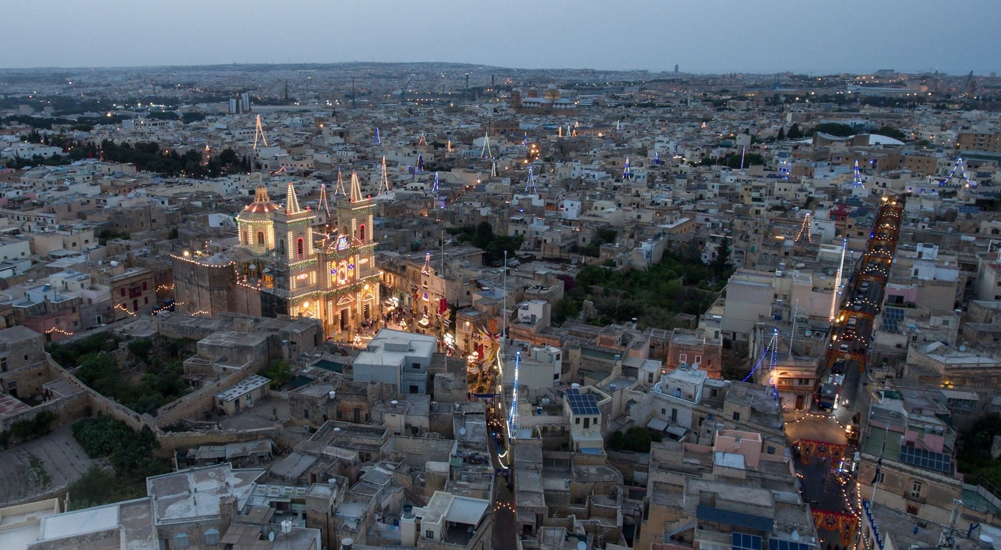 The illuminated church and surrounding village at dusk