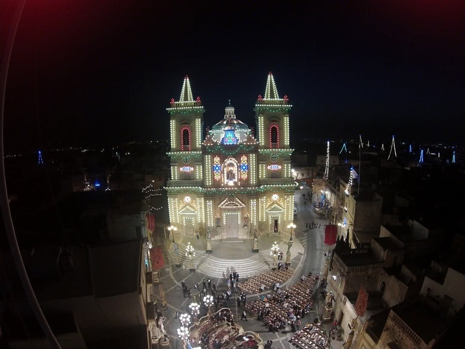 An elevated night view of the church and square