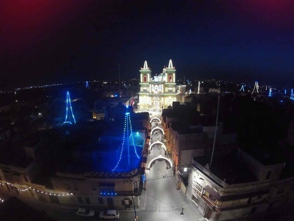 A lit street leading to the church at night