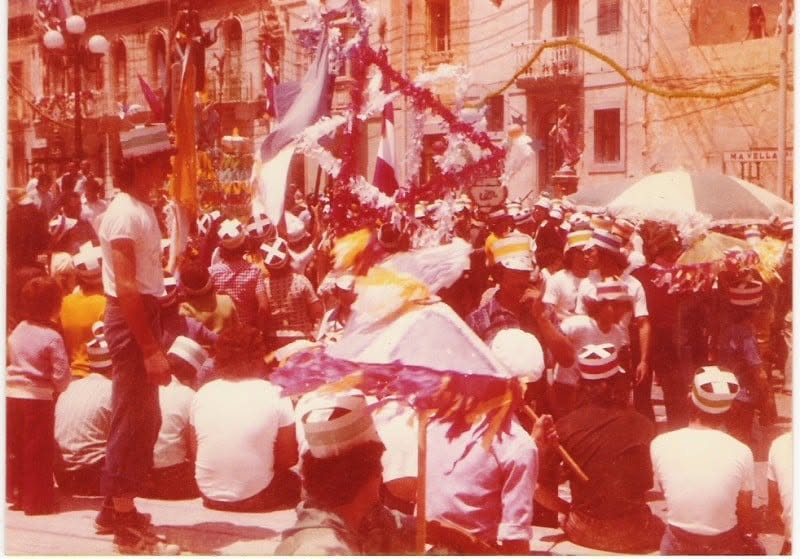 A crowd beneath festive decorations