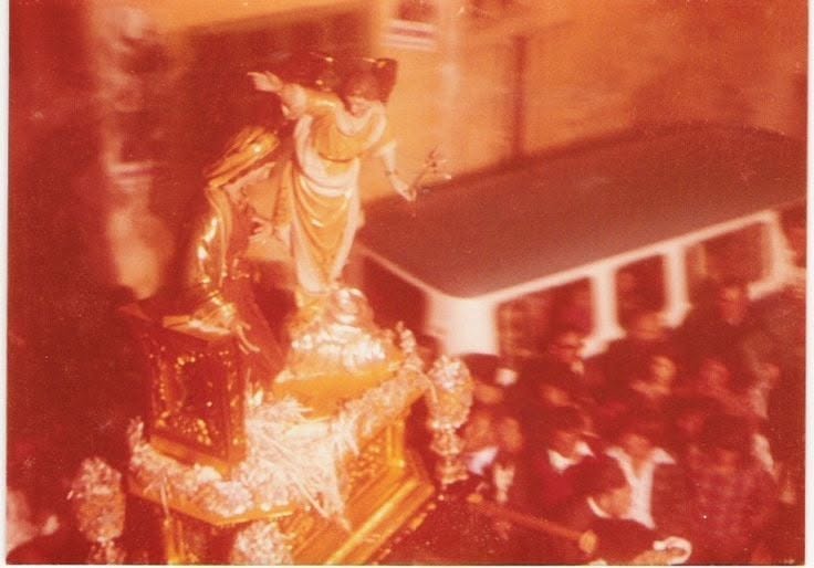 Annunciation statues carried among a crowd