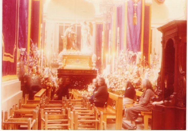 People seated inside a decorated church