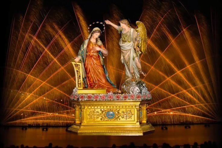 Annunciation statues with a fireworks background
