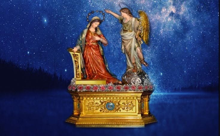 Annunciation statues with a starry background