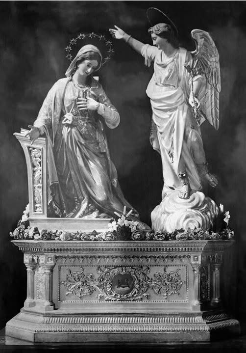 Annunciation statues on an ornate pedestal