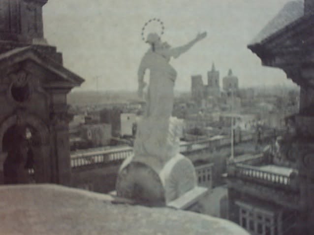 A rooftop statue above the village